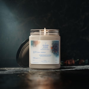 May include: A lit, beige candle in a glass jar with a silver lid. The label reads "CLEAN CODE" with the scent profile "Fresh Linen + Powder + Sandalwood." The background is dark with a blurred effect.