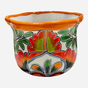 May include: A hand-painted ceramic planter with a vibrant floral design. The planter features a white base with colorful flowers in red, orange, and green. The rim is a bright orange, and the interior is white. A decorative piece for home or garden.