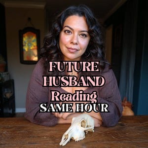 May include: A woman with dark curly hair sits at a wooden table with a skull. Text on the image reads "FUTURE HUSBAND Reading SAME HOUR". The woman wears a brown top and looks directly at the camera.