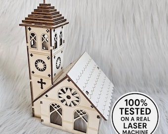 May include: A wooden church model with a tall steeple and cross, featuring intricate cut-out windows and a decorative roof. The model includes a round window and the text "100% TESTED ON A REAL LASER MACHINE".