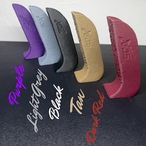 May include: Five angled, textured grips in purple, light grey, black, tan, and dark red. Each grip has the text "SCX" on the side. The colors are labeled in cursive script below each grip.