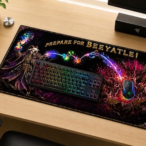 May include: A rectangular desk mat featuring a fantasy illustration of a goat-like figure casting colorful magic spells. The text PREPARE FOR BEEYATLE! is printed in gold. A black mechanical keyboard and a black gaming mouse are placed on the mat.
