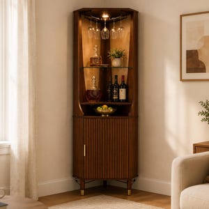 May include: A tall, dark wood corner bar cabinet featuring a fluted lower cabinet door, a glass shelf, and an upper section with built-in stemware racks for hanging wine glasses. The unit is illuminated by interior lighting and stands on four legs.