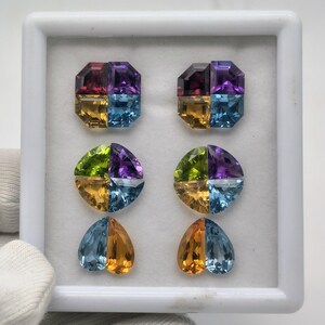 Puede incluir: Una colección de seis piedras preciosas facetadas dispuestas en una caja de presentación blanca. La fila superior presenta dos piedras cuadradas, la fila central dos piedras circulares y la fila inferior dos piedras en forma de corazón.