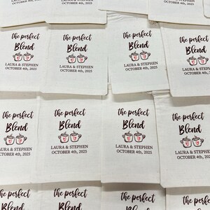May include: Off-white canvas favor bags with the text "the perfect Blend" in a script font, and two coffee cup illustrations with hearts. The bags are personalized with "LAURA & STEPHEN OCTOBER 4th, 2025".