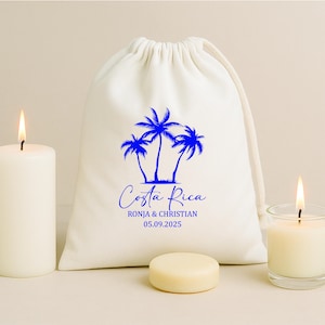 May include: A white drawstring bag featuring a blue palm tree design and the words "Costa Rica". The names "RONJA & CHRISTIAN" and the date "05.09.2025" are printed below.
