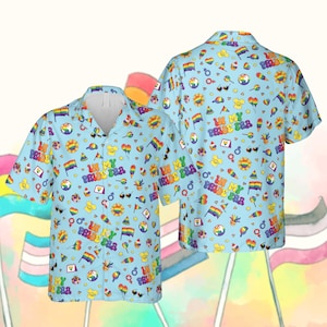 May include: Light blue button-down shirt with a repeating pattern of Pride-themed icons, including rainbows, flags, and the text "IN MY PRIDE ERA". The shirt has a classic collar and short sleeves.