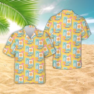 May include: A short-sleeved button-down shirt in a bright yellow hue featuring a repeating pattern of stylized suns, palm trees, and pink seashells framed within light blue rectangular borders across the entire fabric surface.