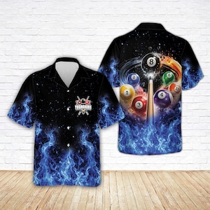 May include: A short-sleeve button-down shirt featuring a black background with vibrant blue flames at the bottom. The front displays a pool-themed logo with the text YOURNAME. The back shows a pool cue striking billiard balls in a swirl.