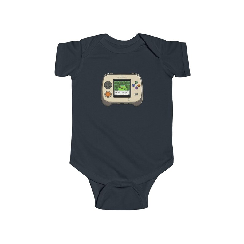 May include: A navy blue baby bodysuit featuring a retro handheld video game graphic. The game console is beige with a green screen displaying a pixelated landscape. It has orange, blue, and purple buttons.