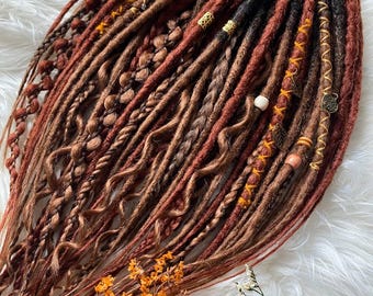Boho-style dreadlocks in blonde and copper tones. Hand-applied hair extensions.
