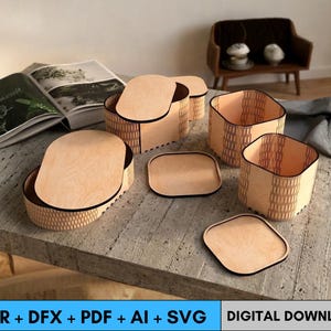 May include: A collection of wooden storage boxes and lids with a natural wood finish and black trim. The boxes are various sizes and shapes, including oval and square. The image also includes the text "CDR + DFX + PDF + AI + SVG DIGITAL DOWNLOAD".