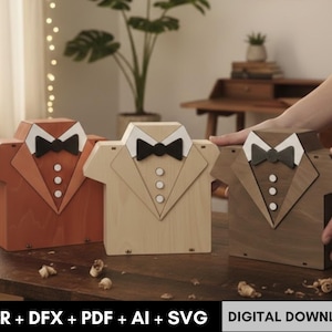 May include: Three wooden boxes shaped like tuxedo shirts in shades of orange, beige, and brown. Each box features a white collar, black bow tie, and three white buttons. The boxes are displayed on a wooden surface.