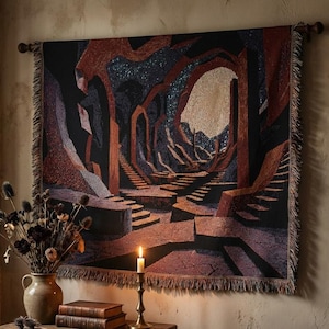 May include: A woven tapestry depicting a surreal landscape with archways, steps, and a central light source. The color palette includes shades of black, brown, and beige. The tapestry is fringed and mounted on a wooden rod, creating a unique wall hanging.