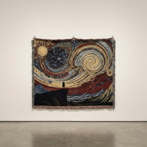 May include: Woven tapestry depicting a starry night scene with a figure standing on a cliff. The artwork features swirling patterns in shades of yellow, blue, red, and black. The tapestry is rectangular and hangs on a white wall.