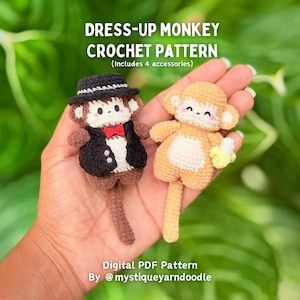 May include: Two small crocheted monkeys, one dark brown wearing a black hat, waistcoat, and red bow tie, and one light tan holding a yellow banana. Text reads: DRESS-UP MONKEY CROCHET PATTERN (Includes 4 accessories) Digital PDF Pattern By @mystiqueyarndoodle
