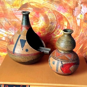 Vintage hand-painted rustic terracotta pots with geometric motifs