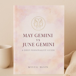 Op de afbeelding: Een boek getiteld "May Gemini vs June Gemini: A Deep Personality Guide" met een cover in aquarel-stijl in roze en paarse tinten. De cover toont een gouden illustratie van twee gezichten en de woorden "Mystic Moon".