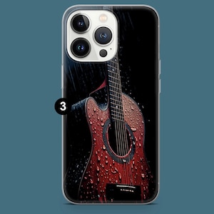 May include: A phone case featuring a detailed illustration of a classical acoustic guitar in the rain. The guitar is a reddish-brown color with water droplets, set against a dark background. The number "3" is visible.