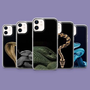 May include: A collection of phone cases featuring detailed images of various snakes. The cases showcase a range of snake species, including a cobra, a green snake, and a blue snake, against a black background.