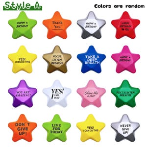May include: A collection of star-shaped objects in various colors, each with a different motivational message. The stars include phrases like "Happy Birthday," "Thank You," and "You Are Amazing!" The text "Colors are random" is also present.