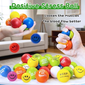 May include: A collection of colorful stress balls with smiley faces and motivational phrases. The balls are in various colors, including red, blue, yellow, green, and orange. The text "Positive Stress Ball" is at the top of the image.