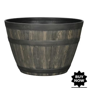 May include: A large, round planter with a faux wood grain finish. The planter is gray with dark gray bands and trim. The words "BUY NOW" are in a black starburst graphic in the lower right corner.