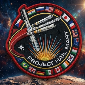 May include: Embroidered patch with a black background, featuring a spacecraft design and the text "PROJECT HAIL MARY". The patch is bordered by a red ring and includes various national flags. A star and a burst of yellow and blue rays are also present.