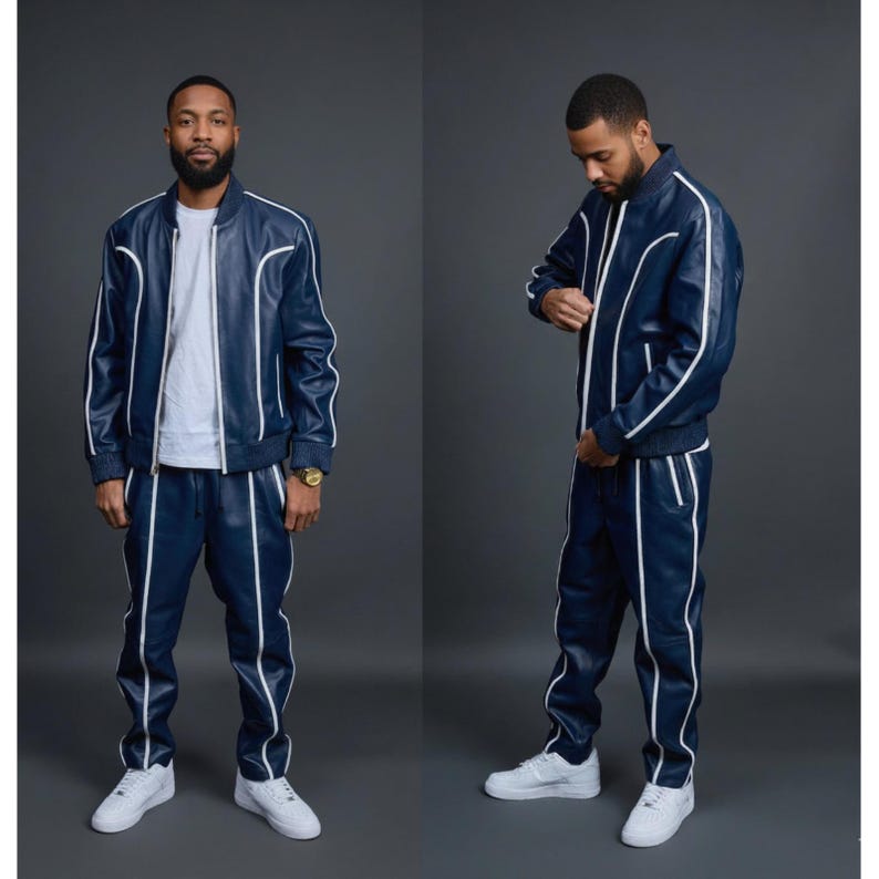 May include: A navy blue tracksuit with white piping. The jacket is a bomber style with a zipper closure. The pants have an elastic waistband. The outfit is paired with white sneakers. The tracksuit is made of a leather-like material.