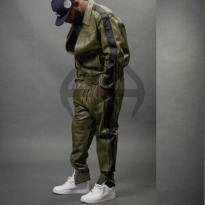 May include: A handmade wooden sign with the text "Welcome" in a whimsical font. The sign is painted white with a distressed finish, and features a decorative floral design in shades of pink and green. It is designed for indoor or outdoor use.