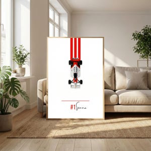 May include: Framed print featuring a Formula 1 race car with red and white stripes. The car is positioned at the top, with the text "#1 Senna" in red at the bottom. The print is displayed in a living room setting.