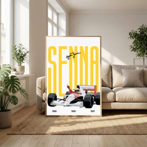 May include: Framed poster featuring a Formula 1 race car in red, white, and black, with the name "SENNA" in large yellow letters. The years 1988, 1990, and 1991 are printed at the bottom. The poster is displayed in a living room.