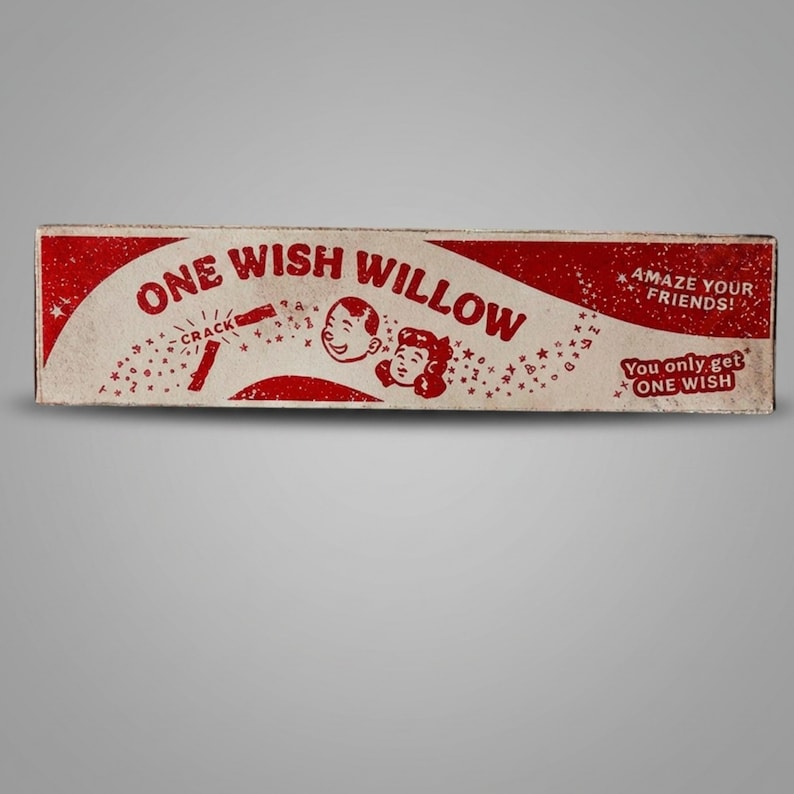 Puede incluir: Una caja rectangular con un dise&ntilde;o en rojo y blanco roto que presenta el texto ONE WISH WILLOW, CRACK, AMAZE YOUR FRIENDS!, y You only get ONE WISH. El gr&aacute;fico incluye ilustraciones de dos rostros sonrientes rodeados de estrellas y s&iacute;mbolos.