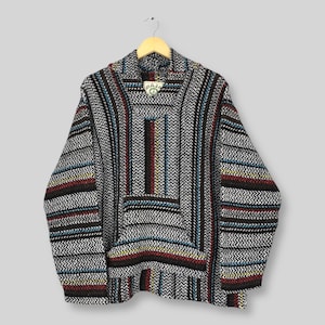 May include: A grey Baja hoodie with a striped pattern in black, red, blue, and yellow. The hoodie has a front pocket and a hood. The word "BAJA" is visible on a tag near the hood.