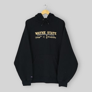 May include: A black hooded sweatshirt featuring the text WAYNE STATE in yellow lettering. Below the text is a mathematical equation and the word Engineering. The hoodie includes a front kangaroo pocket, long sleeves, and a drawstring hood.
