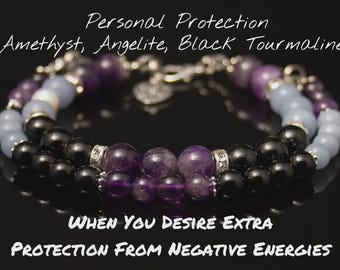 May include: A layered bracelet featuring black, purple, and light blue beads. The bracelet includes Amethyst, Angelite, and Black Tourmaline stones. Text on the image reads "Personal Protection" and "When You Desire Extra Protection From Negative Energies."