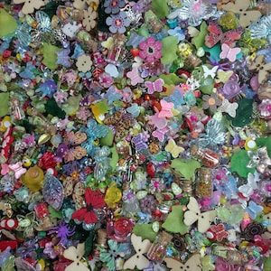 May include: A large assortment of colorful craft supplies, including butterflies, flowers, leaves, and beads. The supplies are perfect for scrapbooking, jewelry making, and other craft projects.