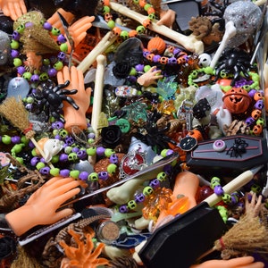 buttons, beads, spiders, skulls, hands, dinosaur skeletons, spoons, pumpkins, bone pens, bones, Halloween figures, and pumpkin bells galore.