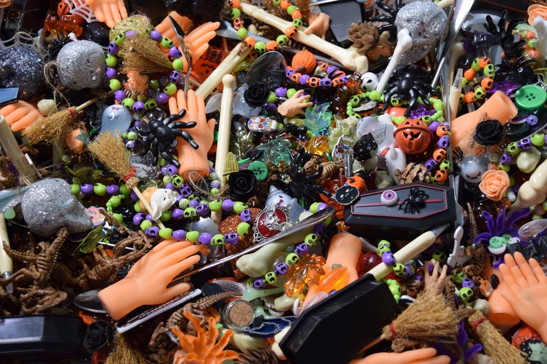 buttons, beads, spiders, skulls, hands, dinosaur skeletons, spoons, pumpkins, bone pens, bones, Halloween figures, and pumpkin bells galore.