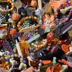 Roses, coffins, bone pens, hands, bats, spider webs, mini brooms, skulls, bracelets, ghosts, Halloween figures, charms, buttons, beads, and other such things are everywhere.
