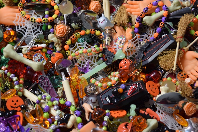 Roses, coffins, bone pens, hands, bats, spider webs, mini brooms, skulls, bracelets, ghosts, Halloween figures, charms, buttons, beads, and other such things are everywhere.