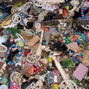 May include: A collection of assorted craft supplies, including wooden gears, corks, beads, playing cards, and decorative elements. The items are in various colors and textures, creating a visually rich and diverse assortment for crafting projects.