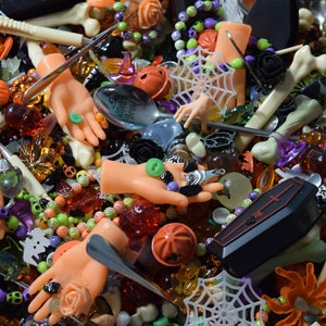 Spider webs, coffins, bats, skeletons, skulls, bracelets, bone pens, doll hands, mini hands, pumpkin bells, mini roses and so much more cover the page.