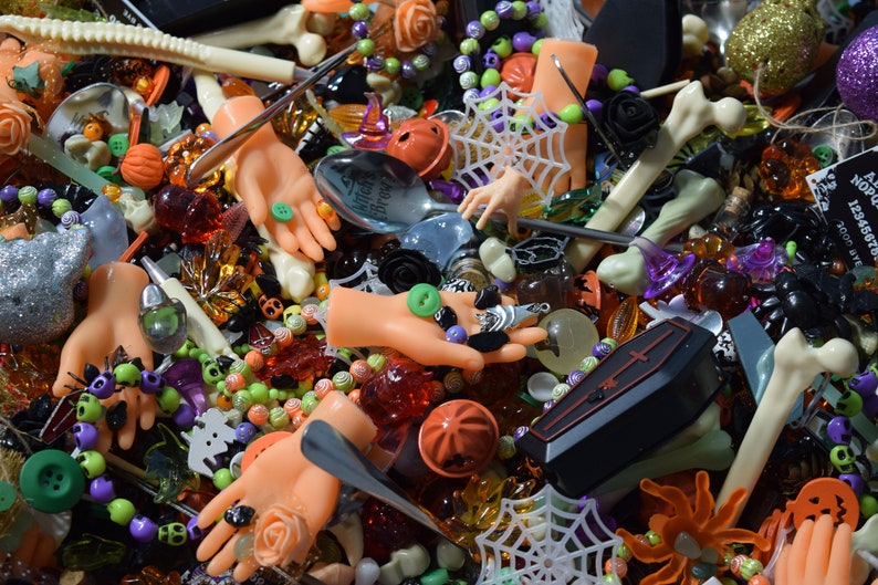 Spider webs, coffins, bats, skeletons, skulls, bracelets, bone pens, doll hands, mini hands, pumpkin bells, mini roses and so much more cover the page.