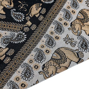 May include: A close-up of a fabric with a repeating pattern of elephants and paisley designs. The fabric is in shades of black, brown, and white.