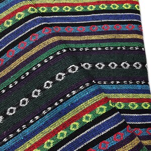 May include: A close-up of a colorful woven fabric with a striped pattern. The fabric features bands of blue, red, yellow, green, and black, with white and red circular accents. The fabric is folded, revealing its texture and design.