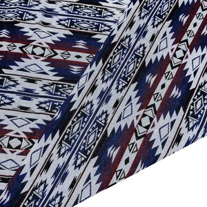 May include: A close-up of a fabric with a blue, white, and red geometric pattern. The fabric is folded in half, showing the pattern on both sides.