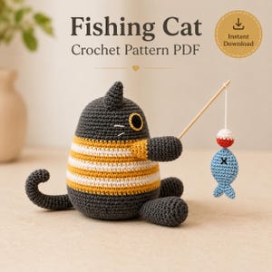 May include: A crochet pattern PDF titled Fishing Cat featuring a dark gray cat with a yellow and white striped midsection, holding a wooden fishing rod with a small light blue fish attached by a white string. The text reads Fishing Cat Crochet Pattern PDF.