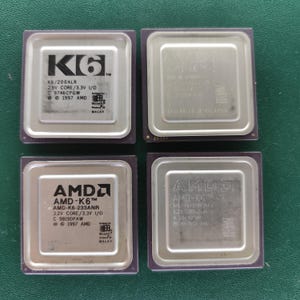 May include: Four square AMD K6 series computer processors with metallic silver heat spreaders and dark purple substrates. Each unit features printed technical specifications, model numbers, and the Microsoft Windows 95 logo. The processors are arranged in a two-by-two grid layout.