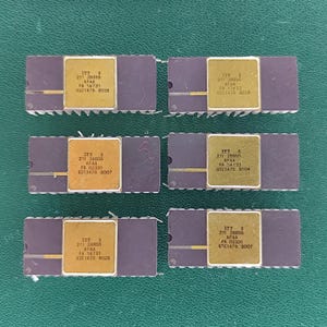 May include: Six rectangular dark purple integrated circuit chips arranged in two columns. Each chip features a central gold-colored square plate with black text reading ITT 211 28855 AFAA FA 14731 UIC1A75 9026 or similar variations of these codes.
